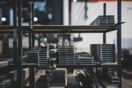 Varieties of steel sitting on a warehouse shelf.