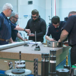 Machine shop technicians inspect a component at Joining Technologies.