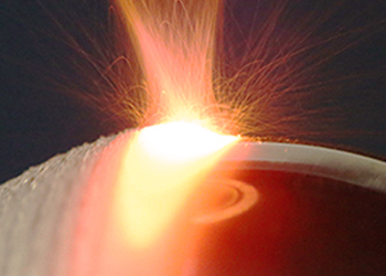 Close up photo of laser cladding being performed on a spherical component.