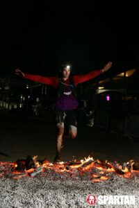 man crosses hot coals during Spartan race