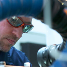 Man in safety glasses operating machinery